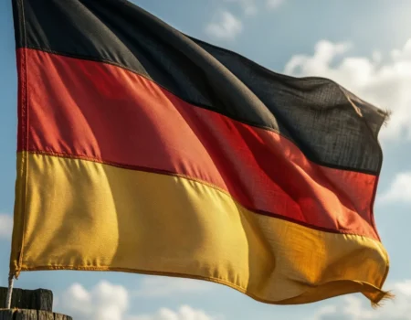 The national flag of Germany with three horizontal stripes of black, red, and gold, waving in the wind.